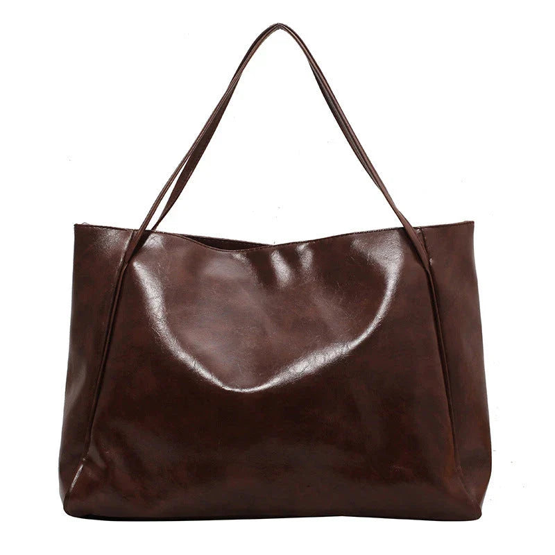 Stylish leather shoulder bag in various colors, including wine red, blue, black, brown, and beige. Showcases a versatile and spacious design for everyday use.