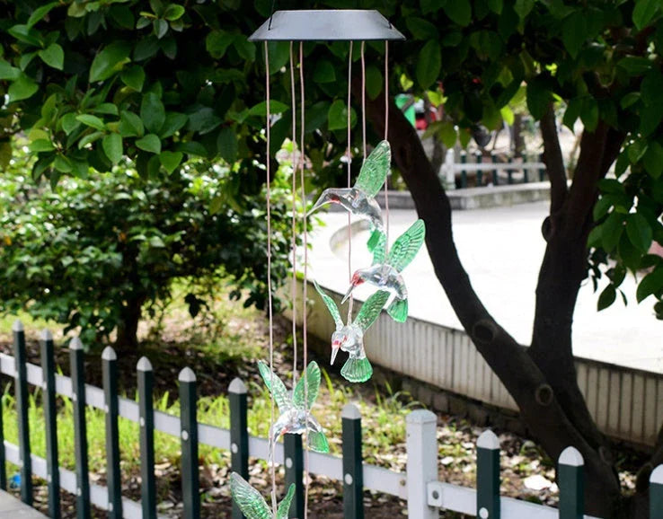 Vibrant solar-powered color changing wind chime with hummingbird and butterfly design for outdoor decor