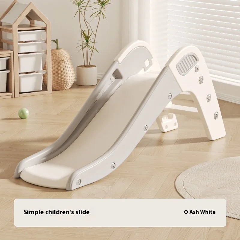 Small blue plastic baby slide for toddlers in a garden setting.