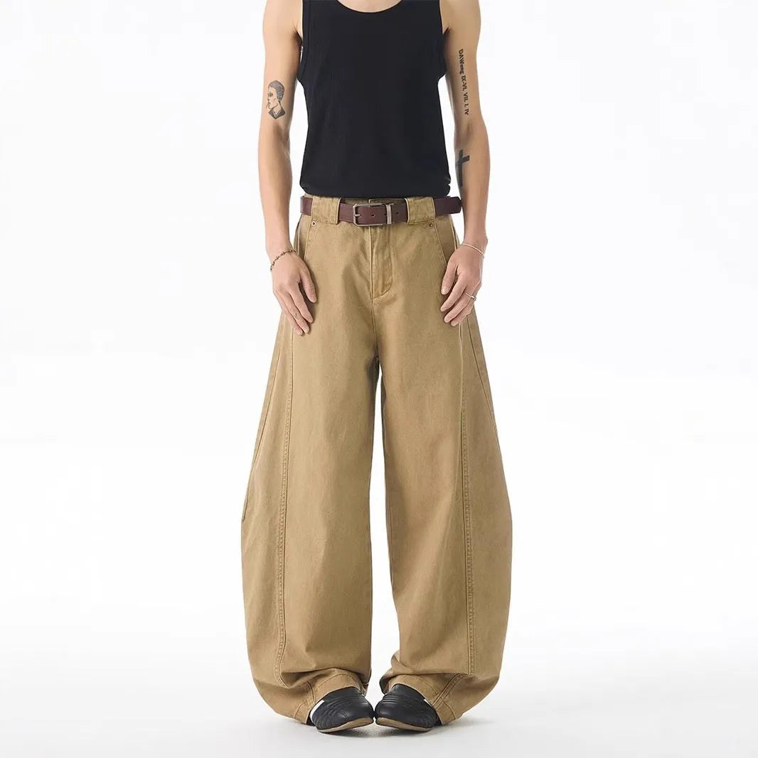 Brown men's loose fit straight leg jeans with a button fly on a mid waist.