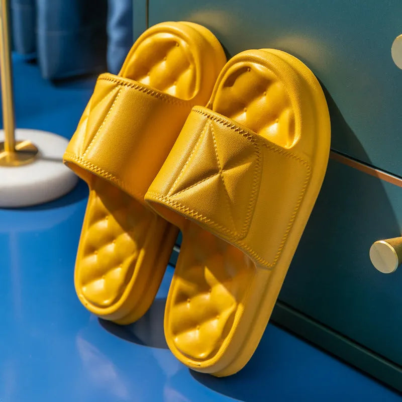 A pair of thick-soled EVA bathroom slippers in a selected colour, showing their injection-moulded non-slip design.