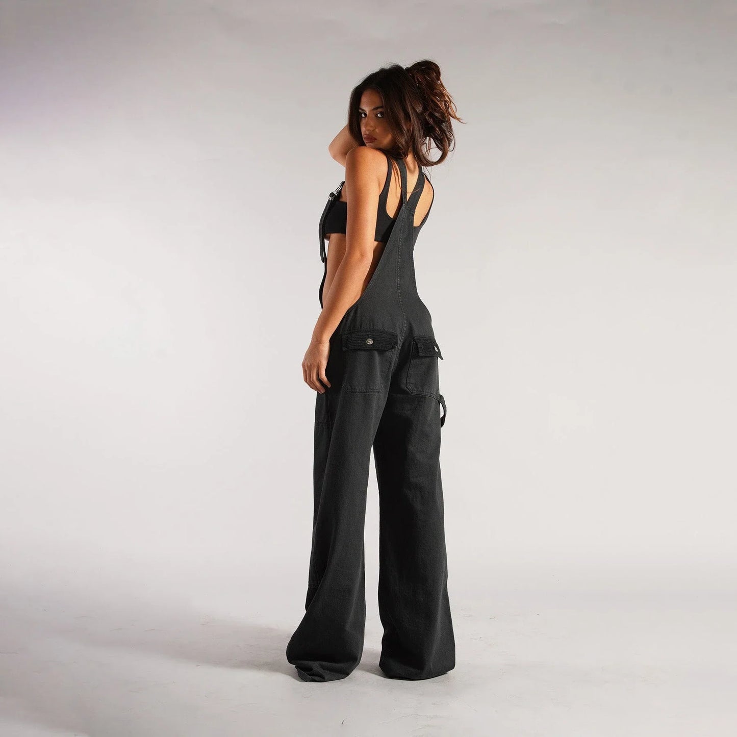 Fashionable Y2K-inspired denim overalls with pockets, suspenders, and a loose, comfortable fit