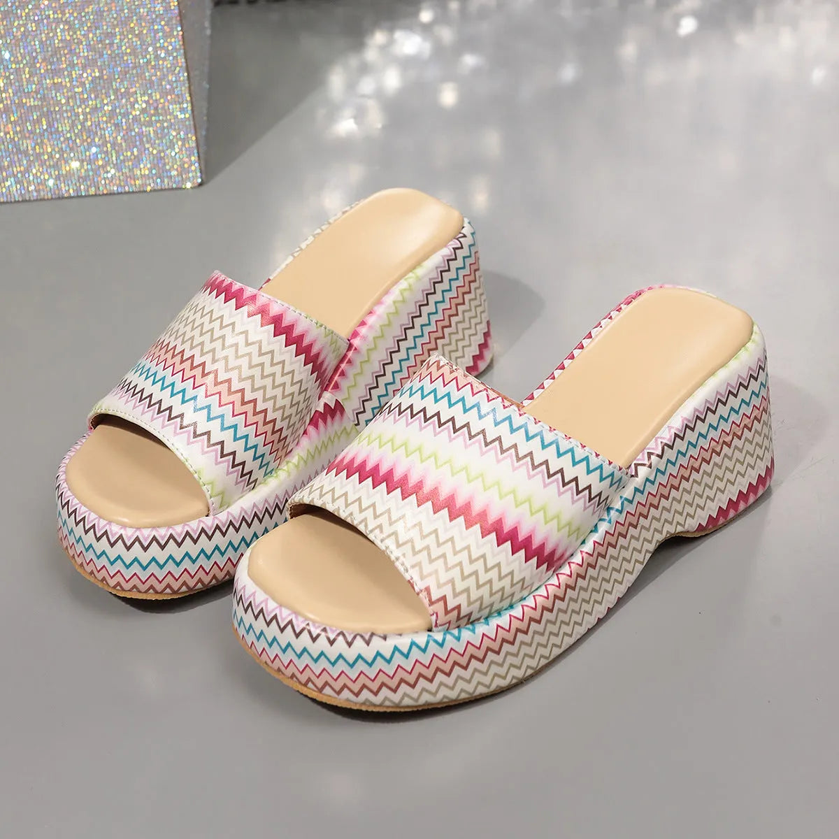 Women's beige wedge sandals with a blue wave print, thick rubber sole, and open fish mouth toe.