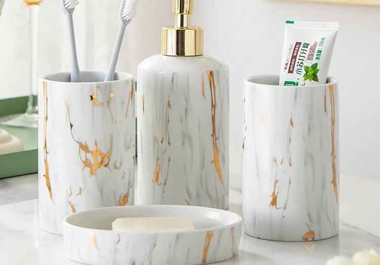 White ceramic bathroom wash kit set with cups, latex bottle and soap box in packaging.