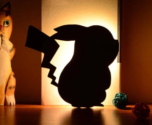 Assorted animal-shaped night lights with motion sensor, including a walking cat, mother and child cat, licking cat, looking back cat, and Pikachu