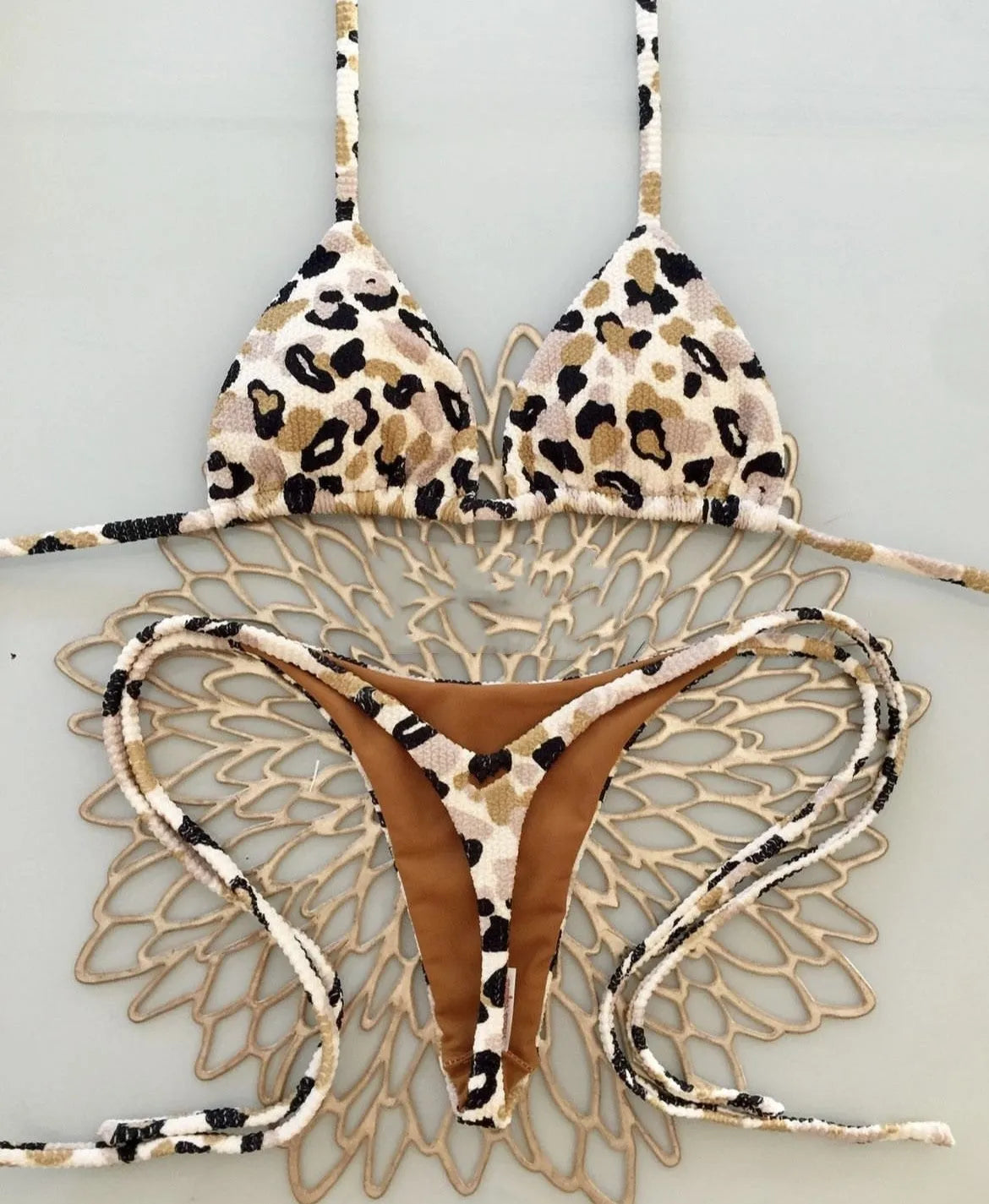 Women's printed bikini swimsuit with briefs style and cotton lining on a mannequin.
