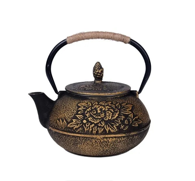 Japanese-style cast iron teapot with lid on a hob, shown in a bronze finish.