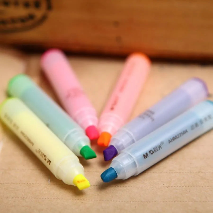Set of six slanted plastic highlighter pens showing six different fluorescent ink colours.