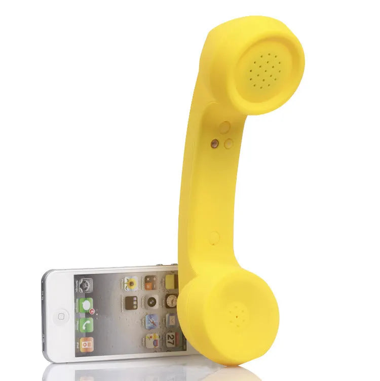 Retro-style Bluetooth wireless headset in hand, showing classic phone handset design and ear hook.