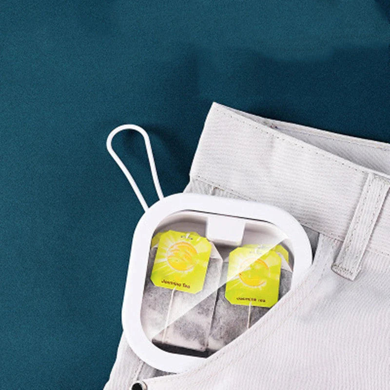 Portable push-button storage box in white color, featuring a sleek and modern design for desk or travel organization