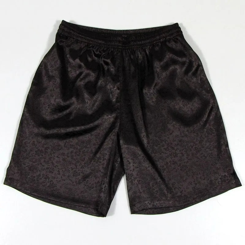 Men's black Tai Chi shorts with a white drawstring elastic waistband laid flat.