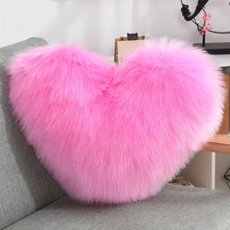 Cozy heart-shaped plush throw pillows in various colors and sizes for living room and bedroom decor