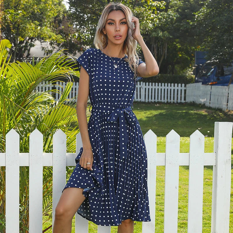 Elegant polka dot midi dress with short sleeves, made of soft viscose fabric and featuring a flattering pleated A-line skirt
