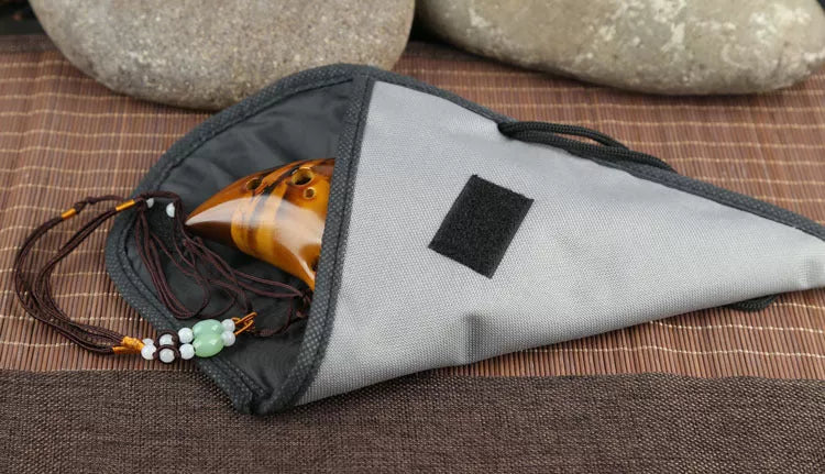 Ceramic 12-hole smoldering ocarina in alto C pitch with nest-inspired design