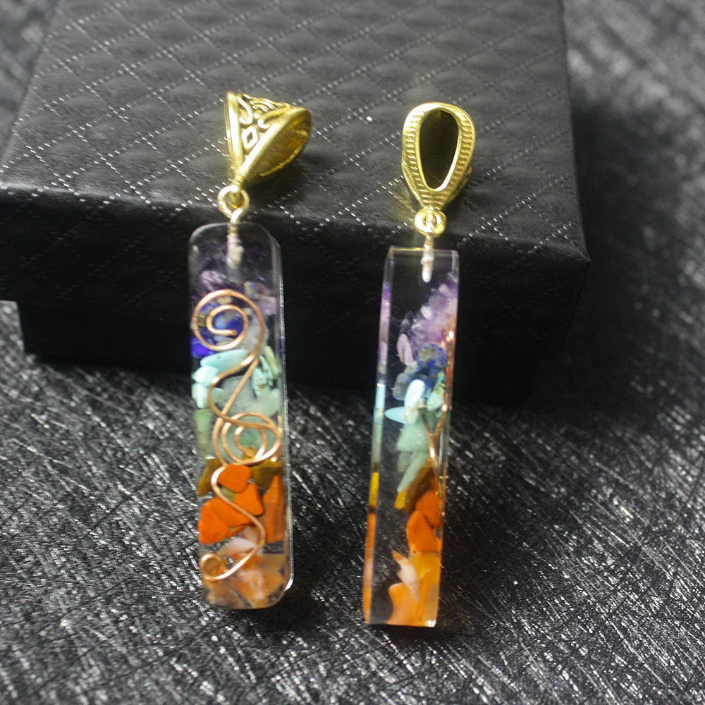 A stylish 7-chakra crystal pendant featuring a unique geometric design and natural stone patterns