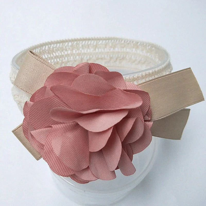 A charming flower headband for babies, featuring a delicate floral design and adjustable fit for a comfortable, stylish accessory.