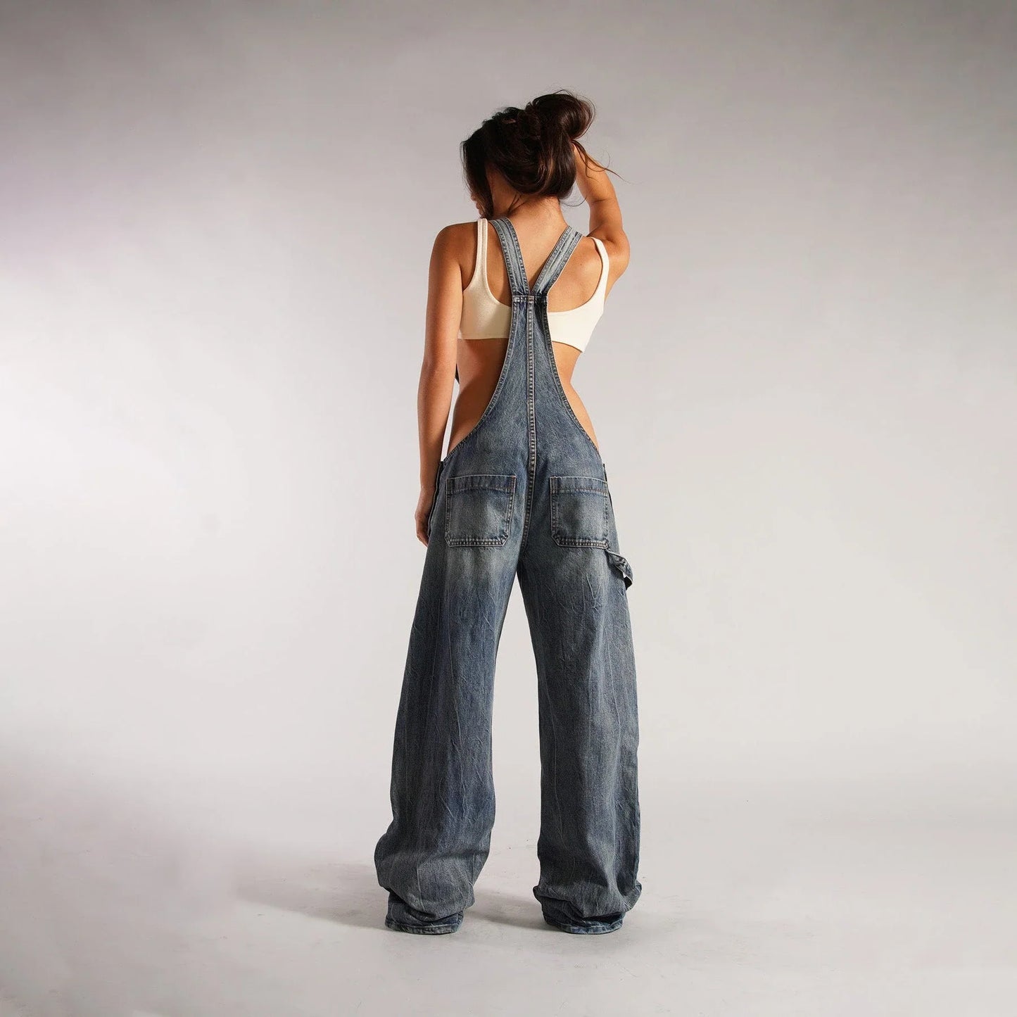 Fashionable Y2K-inspired denim overalls with pockets, suspenders, and a loose, comfortable fit