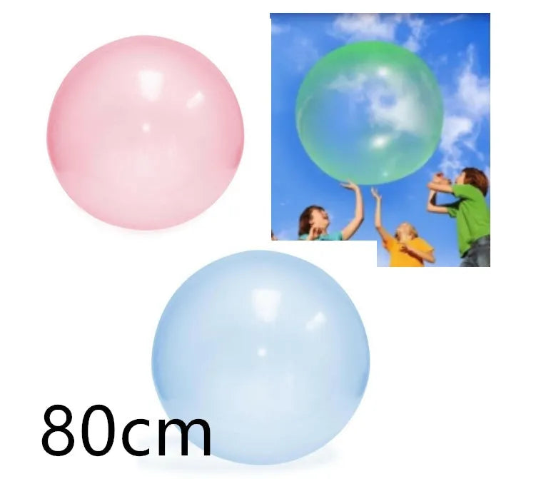 Large pink, yellow, green, and blue inflatable bouncy balls in various sizes for children's play.