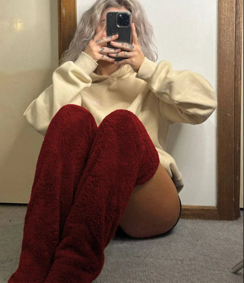 Cozy over-the-knee fuzzy socks in various colors, including brown, blue, dark gray, pink, silver, and more. Comfortable cotton design for warm, snug legs.