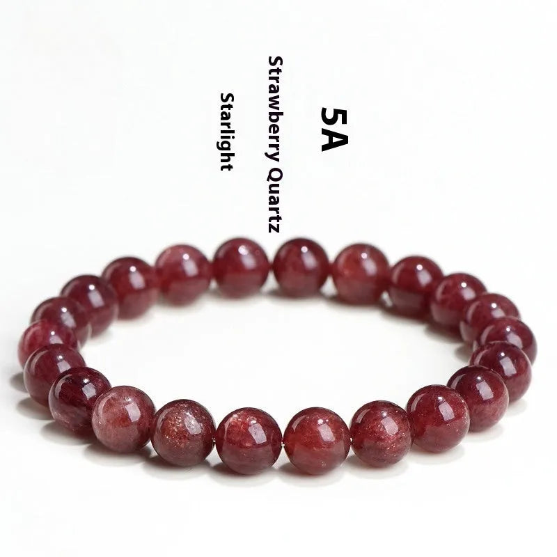 A polished strawberry quartz crystal bracelet in cherry red on a white background, showing geometric beads.