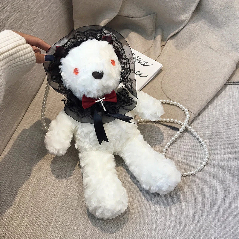 A plush teddy bear crossbody messenger bag with an adjustable shoulder strap and a zippered interior pocket for convenient storage.