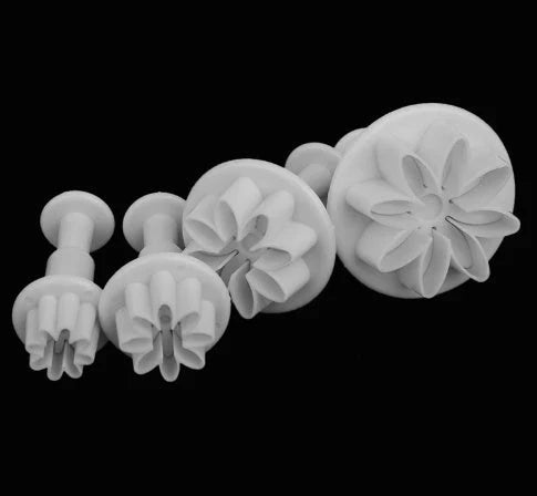 A set of premium cake decorating tools including plungers and knives for creating beautiful flower and shape designs on cakes and baked goods