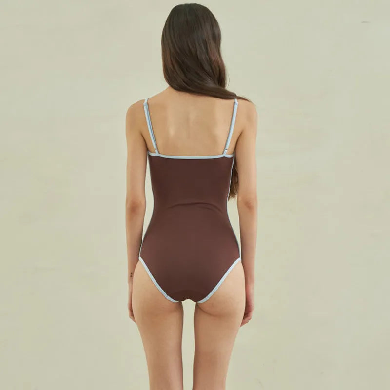 Brown women's one-piece swimsuit with V-neck front and adjustable tie straps at neck and back.