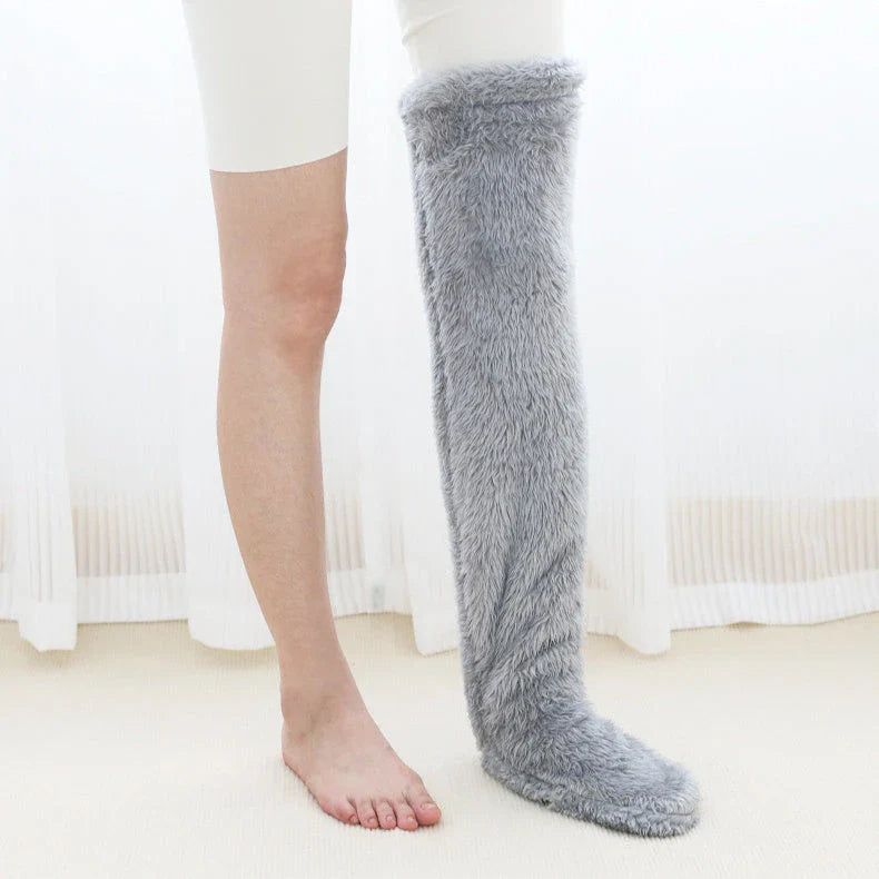 Cozy over-the-knee fuzzy socks in various colors, including brown, blue, dark gray, pink, silver, and more. Comfortable cotton design for warm, snug legs.