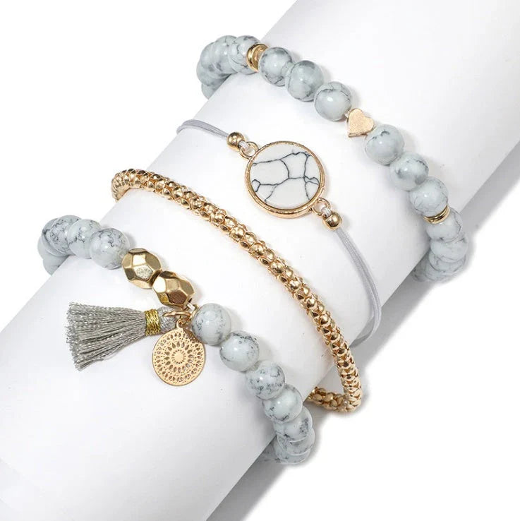 A four-piece geometric pine stone bracelet set made of alloy with an electroplated finish and resin stones, offering a sleek and versatile fashion accessory.