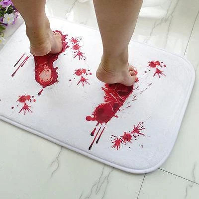 A rectangular bath mat with a vivid, lifelike blood-splatter design made of durable polyester material.