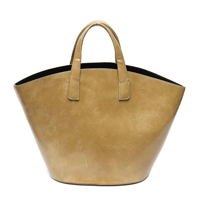 Elegant vegan leather tote bag with a unique bucket shape, versatile carrying options, and a secure zip liner for all your daily essentials.