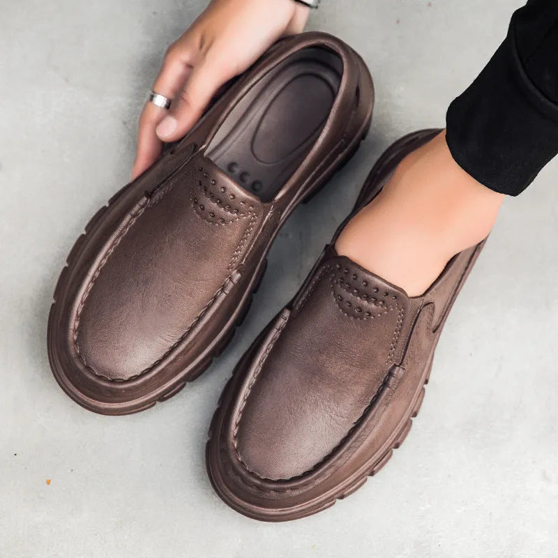 Men's black and brown slip-on work shoes with a mid-top, platform heel, and round toe.