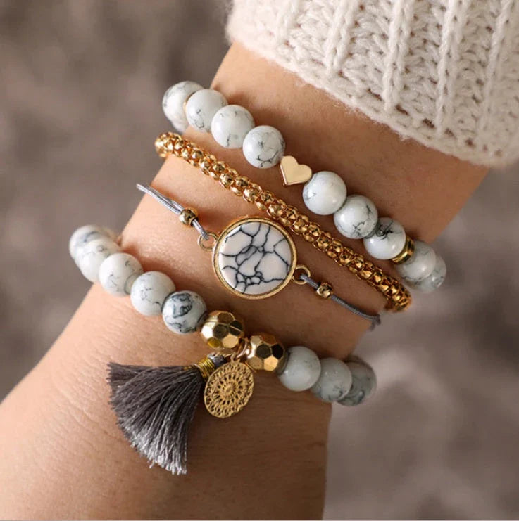 A four-piece geometric pine stone bracelet set made of alloy with an electroplated finish and resin stones, offering a sleek and versatile fashion accessory.