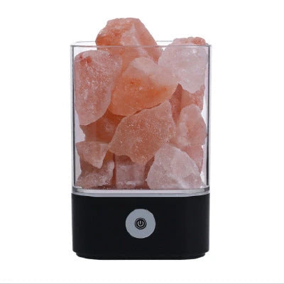 Himalayan salt lamp with warm, soothing glow and color-changing capabilities for air purification and relaxation