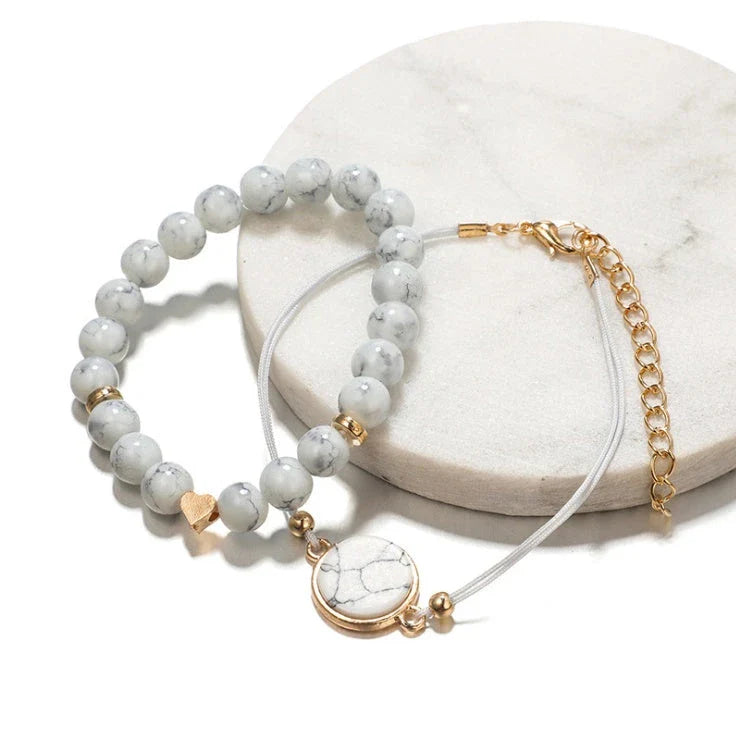 A four-piece geometric pine stone bracelet set made of alloy with an electroplated finish and resin stones, offering a sleek and versatile fashion accessory.