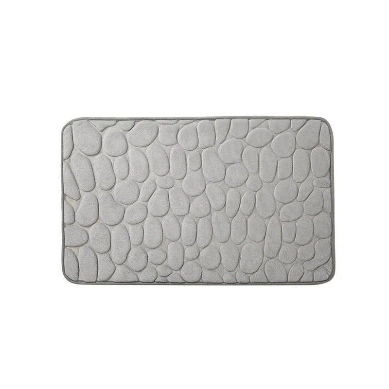 Plush and comfortable memory foam bath mat with cobblestone texture for a soothing, massage-like experience