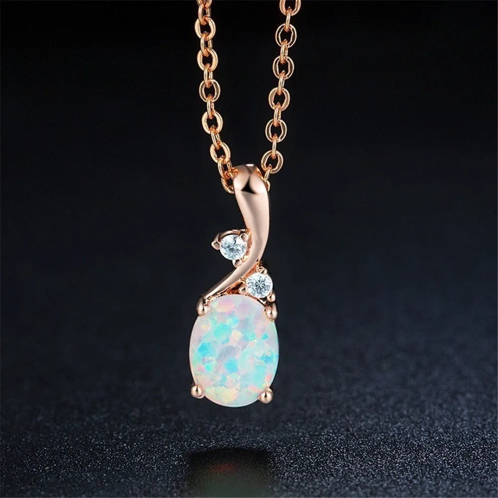 Water drop shaped opal pendant on an adjustable O-chain necklace in rose gold finish.