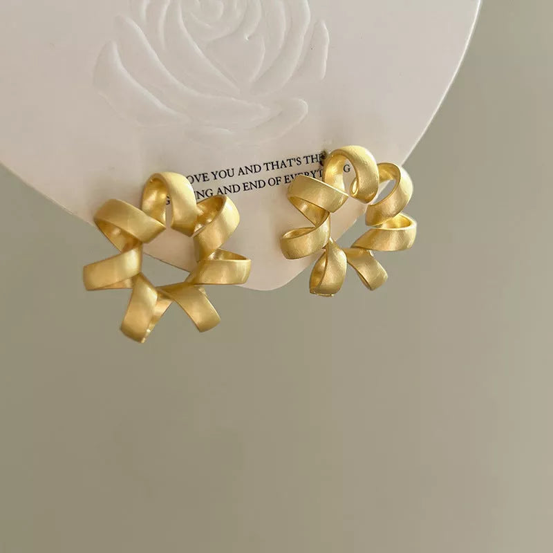Trendy gold circle twists stud earrings for women, perfect for daily wear and parties.