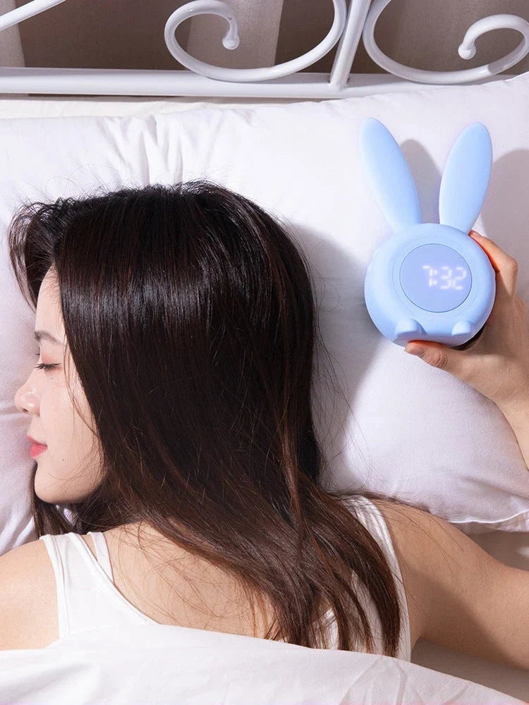 Adorable bunny-eared LED alarm clock with sound control, available in blue, green, and pink colors