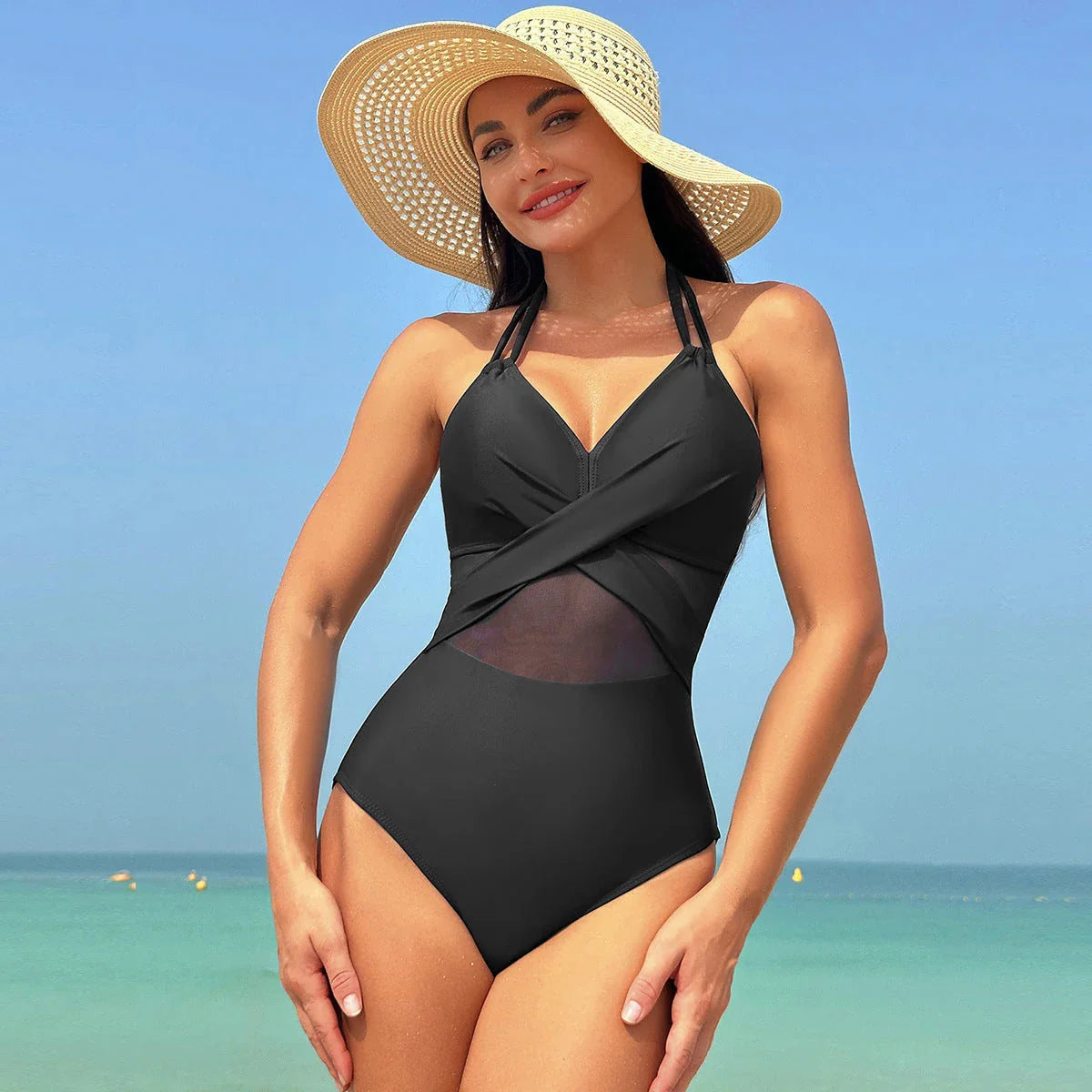 Halter one-piece swimsuit with cross-strap design, available in various solid colors and leopard print