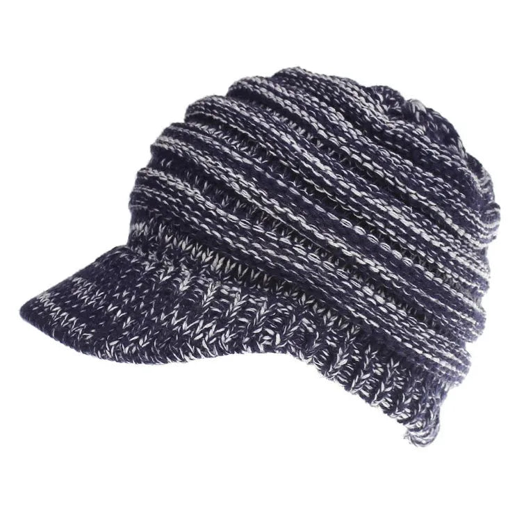 Woman wearing a light grey knitted ponytail beanie with her ponytail pulled through the hole in the back.