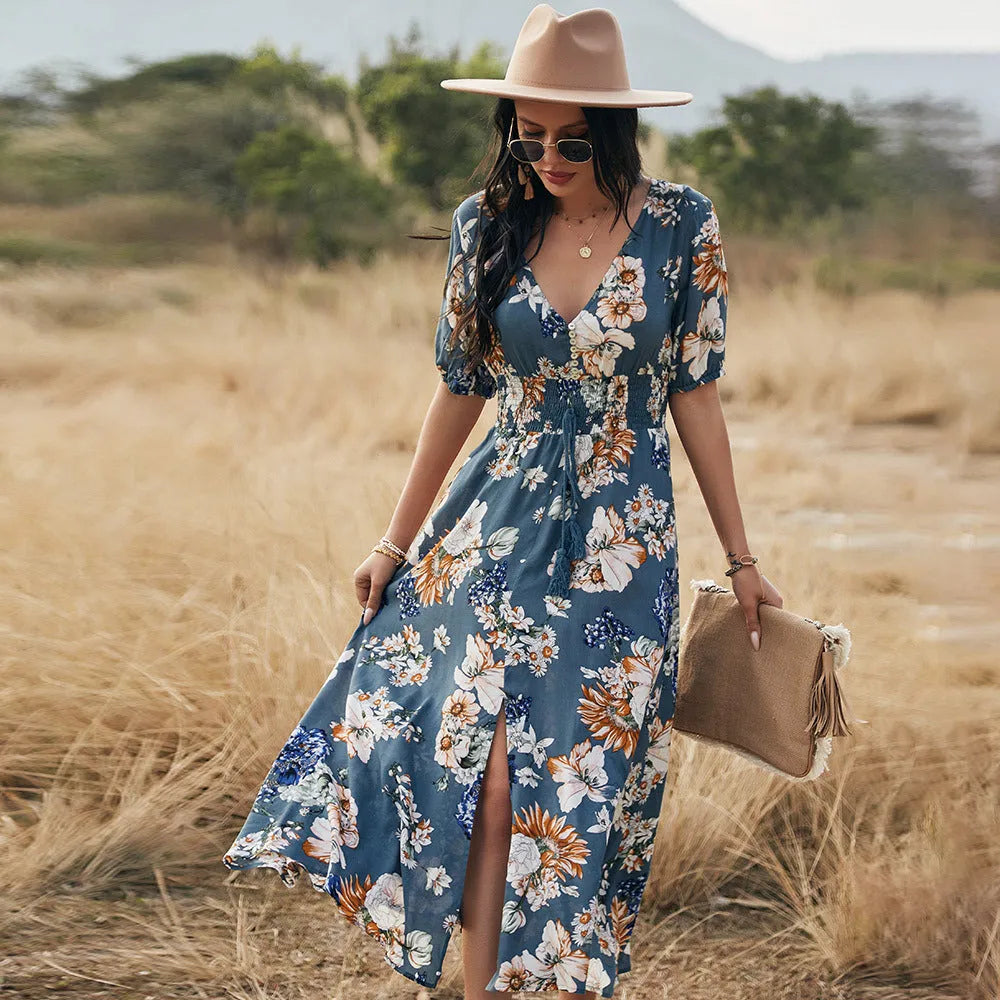 Yellow floral print women's dress with V-neck, short sleeves, elastic waist, and a large hemline midi skirt.