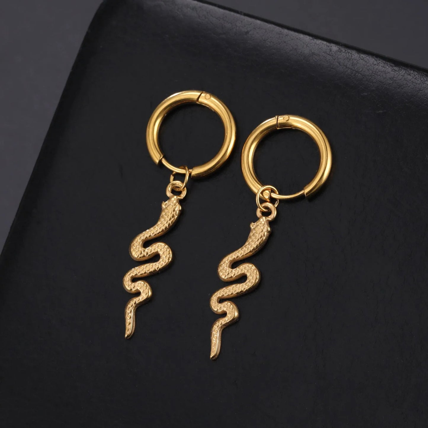 Gold coloured snake-shaped vintage clip-on earrings made from stainless steel.