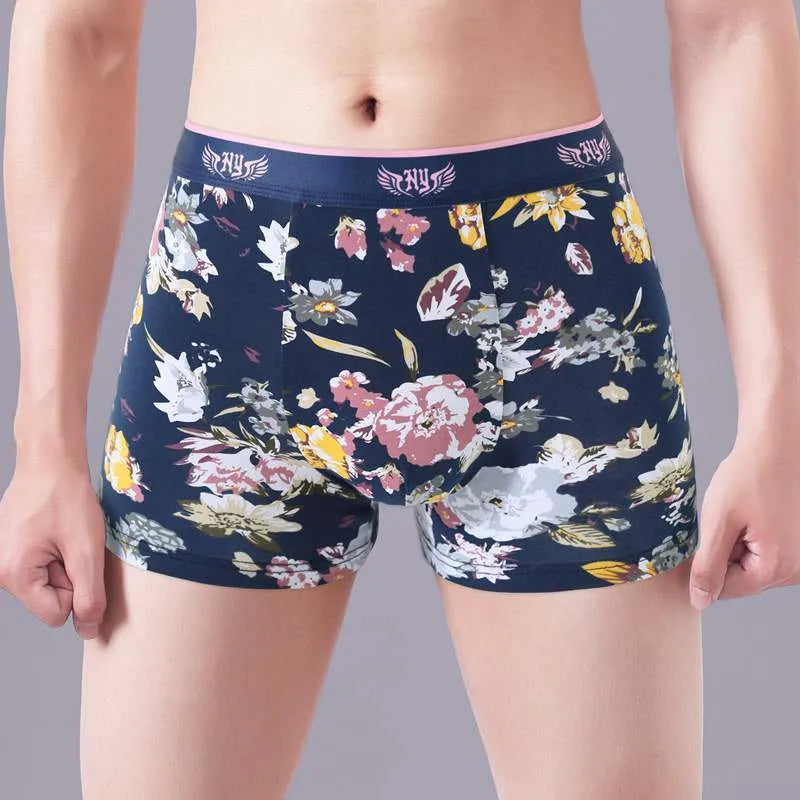 Men's cotton boxer briefs on a size chart showing weights for 3XL to 10XL, in floral colour options.