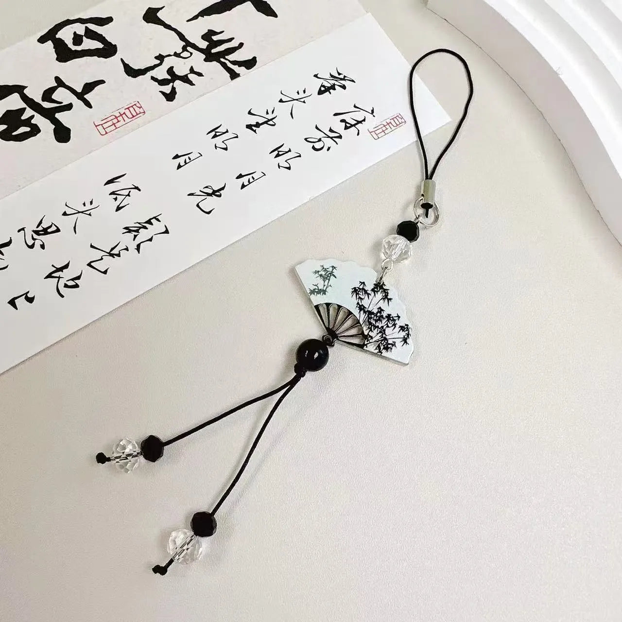 Guofeng Chinese style bead pendant keychain with detailed plants and flowers pattern on a metal clip.