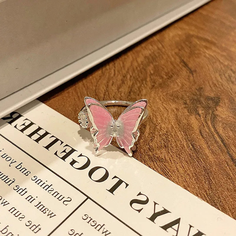 Copper women's ring with Chinese butterfly design and adjustable open loop.