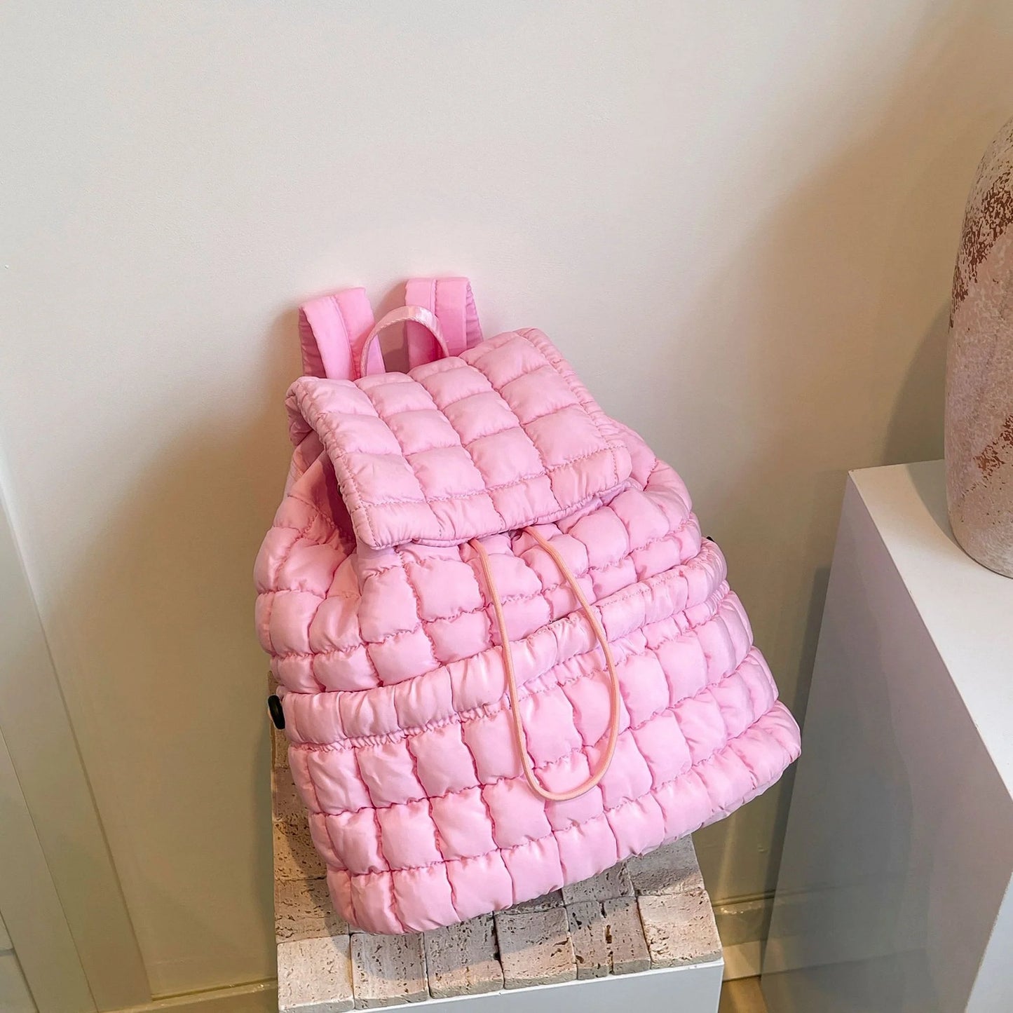 Soft, quilted puffer backpack in a variety of colors, perfect for autumn and winter wear