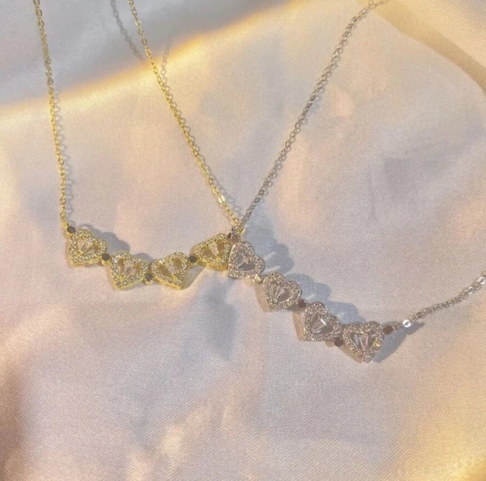 Enchanting magnetic heart-shaped four-leaf clover pendant necklace in gold, silver, and rose gold colors
