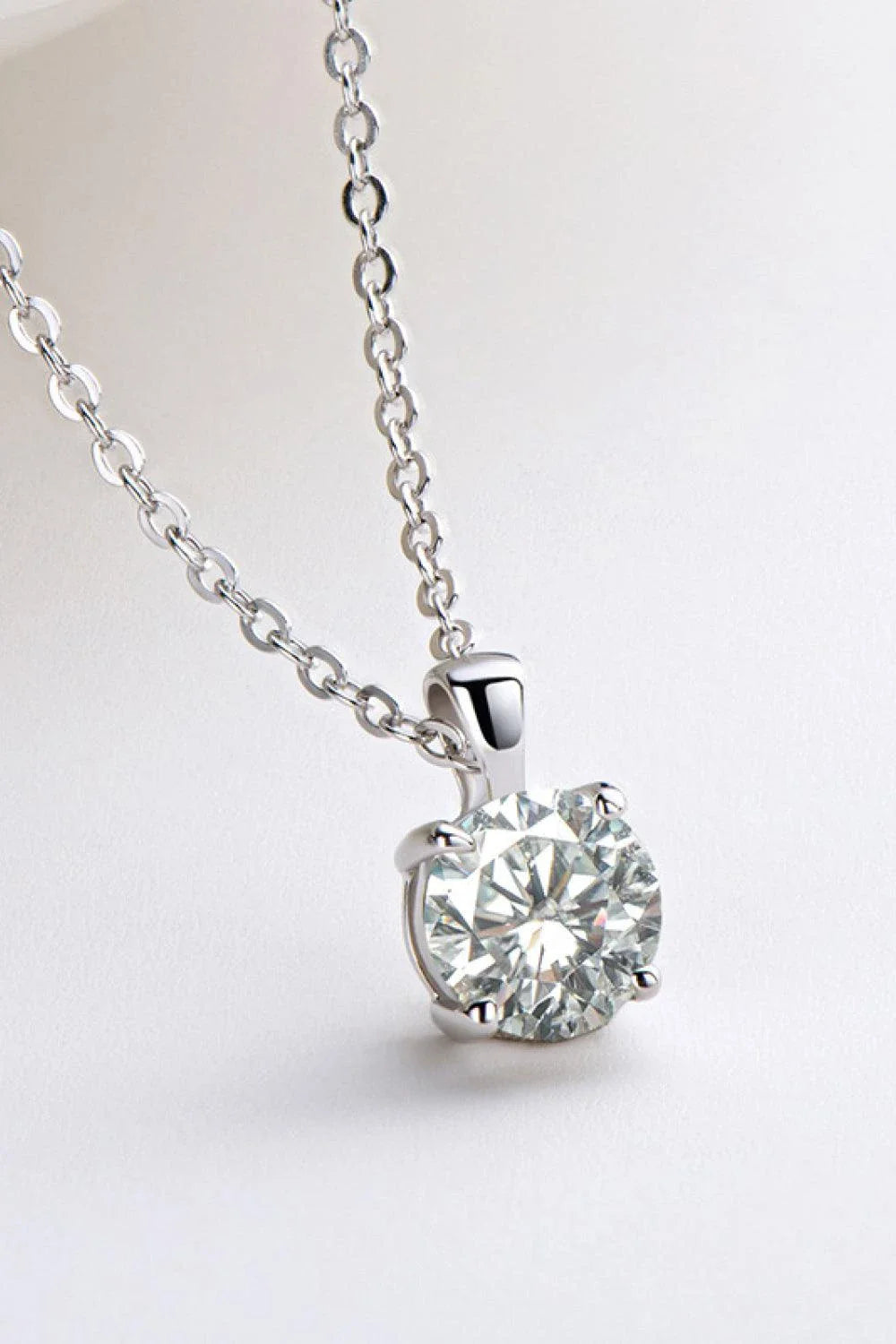 Sparkling 925 sterling silver necklace with a 1 carat moissanite center stone, showcasing a modern, minimalist chain-link design