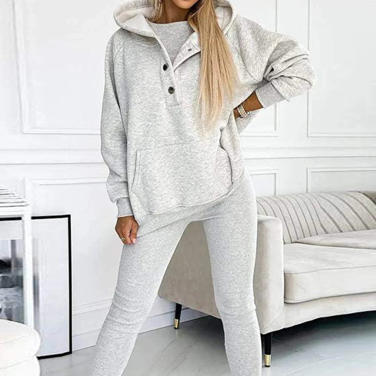 Women's 3-piece sports suit featuring a hooded sweatshirt with pockets and slim trousers
